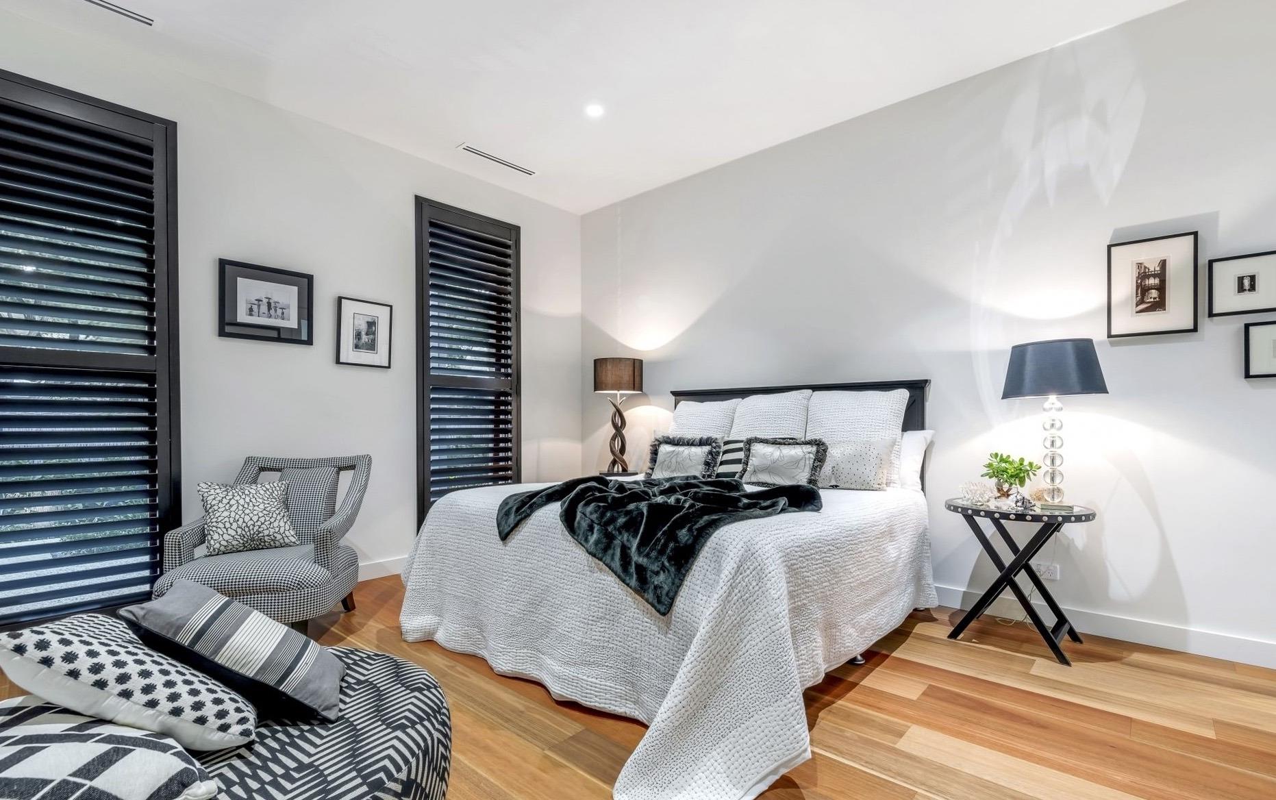 Black Plantation shutters in bedroom